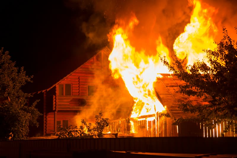 A house on fire at night