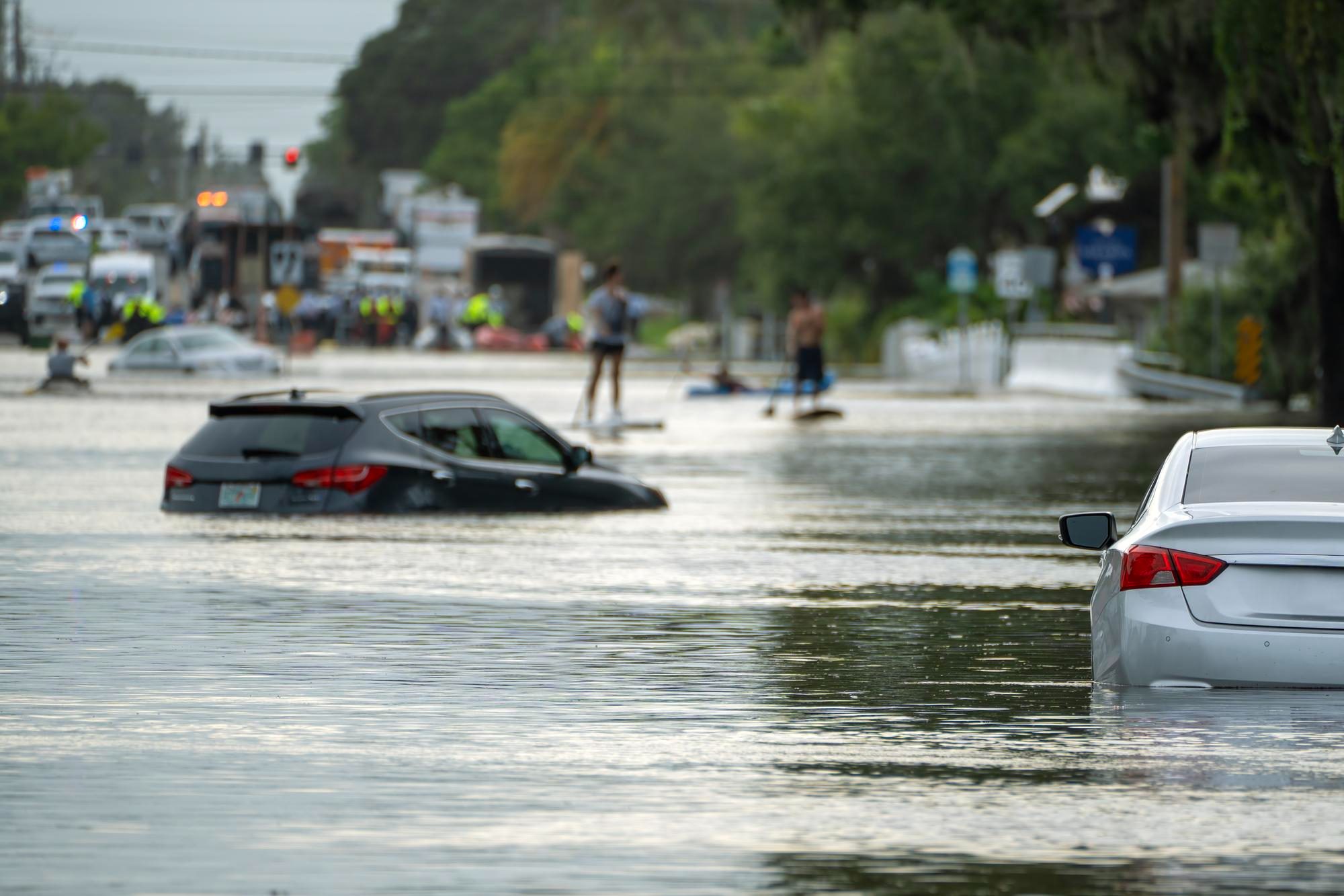Water flooding a Las Vegas street during a monsoon rainstorm, illustrating flash flood risk for Nevada homeowners.